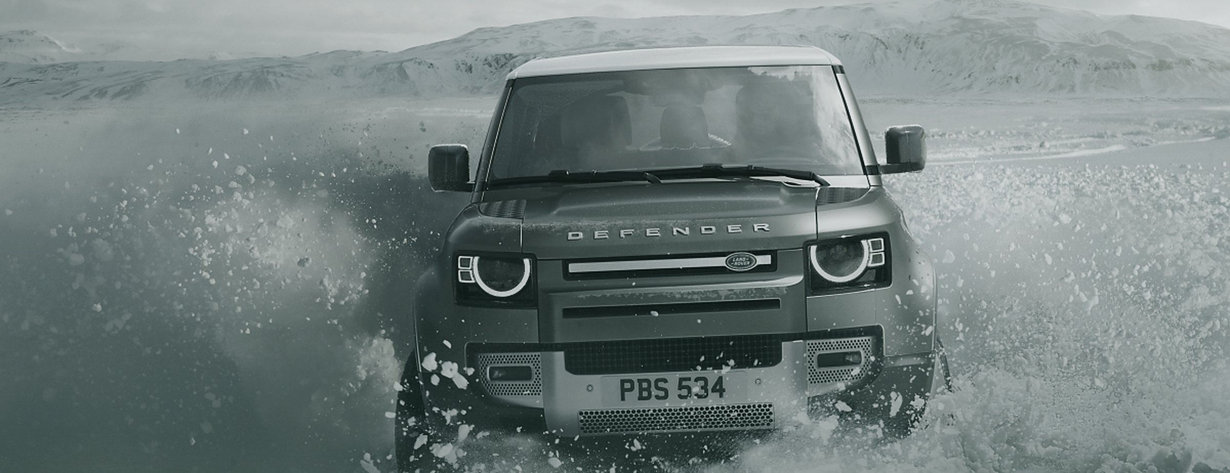 Land Rover Defender driving through snow